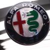 The Alfa Romeo logo badge on a blurry white background.