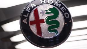 The Alfa Romeo logo badge on a blurry white background.