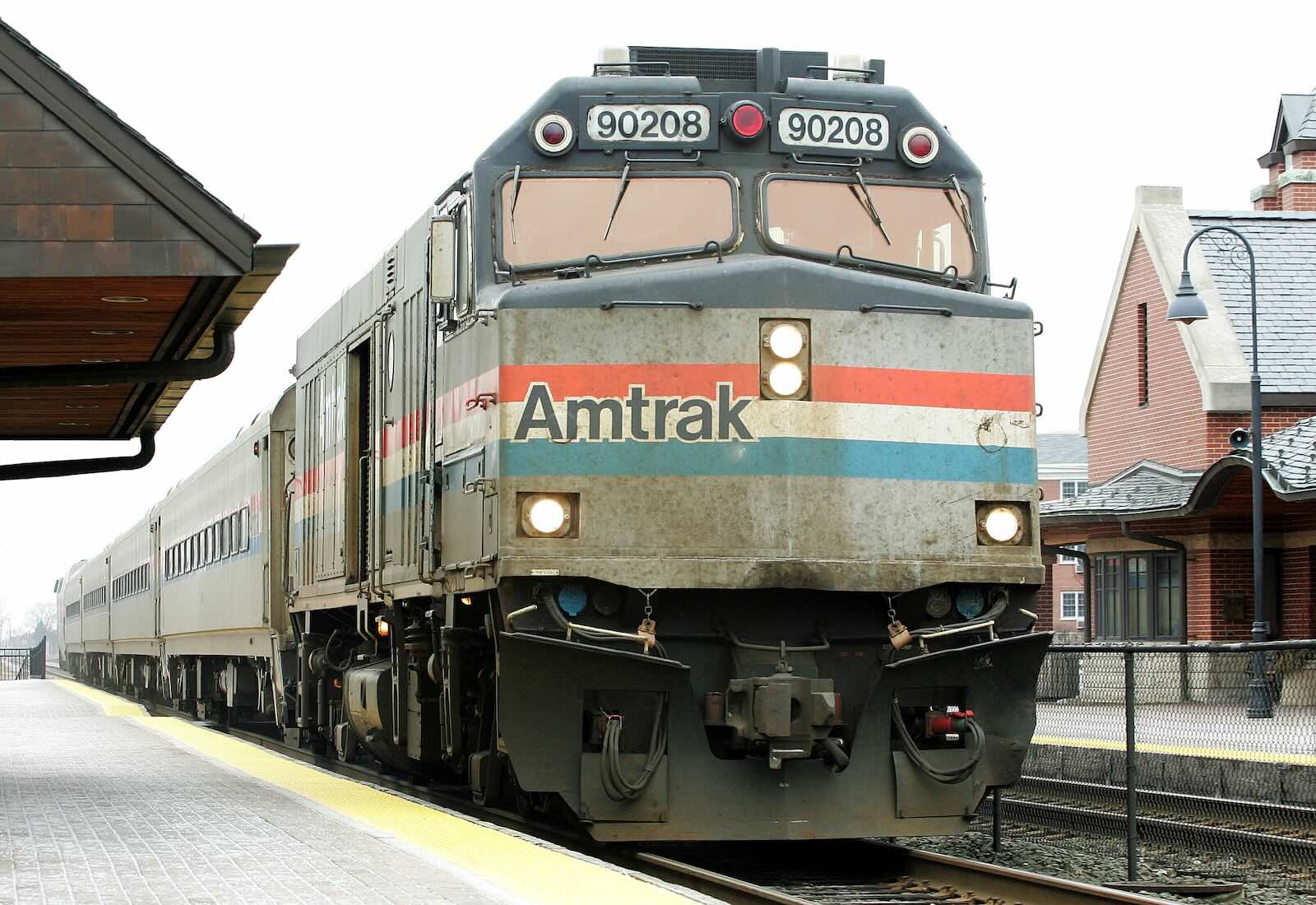 The engine of an Amtrak train, parked at a station.