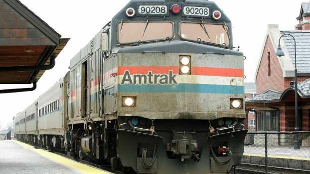 The engine of an Amtrak train, parked at a station.