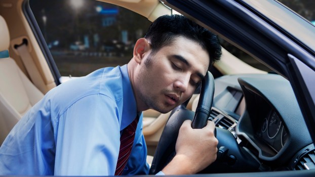A man sleeping in a car