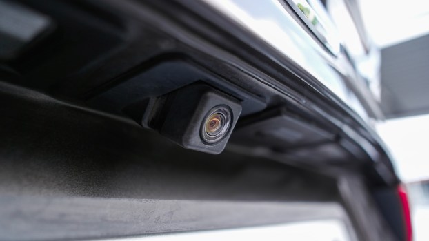 The backup camera above the license plate of a car.