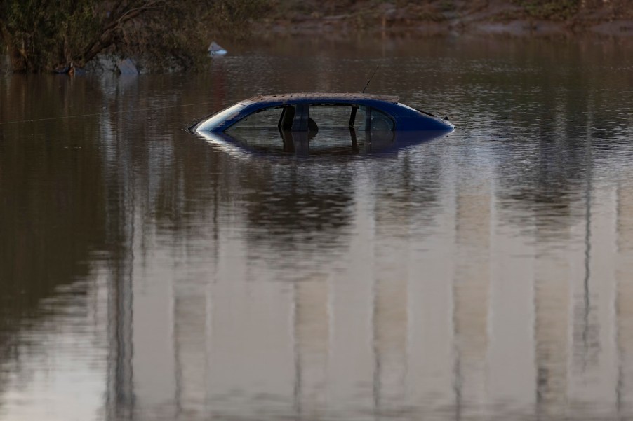 The rooftop of a car sinking into water.