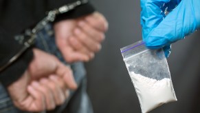 A police officer arresting a man with cocaine