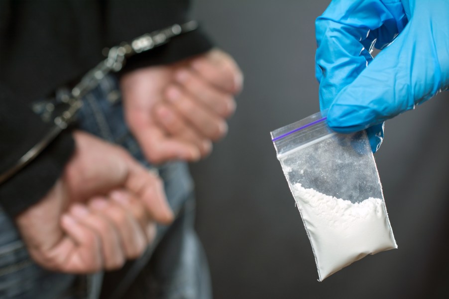A police officer arresting a man with cocaine