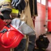 A firefighter holding a helmet