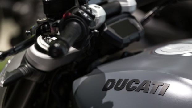 The tank and digital gauge cluster on a gray Ducati motorcycle