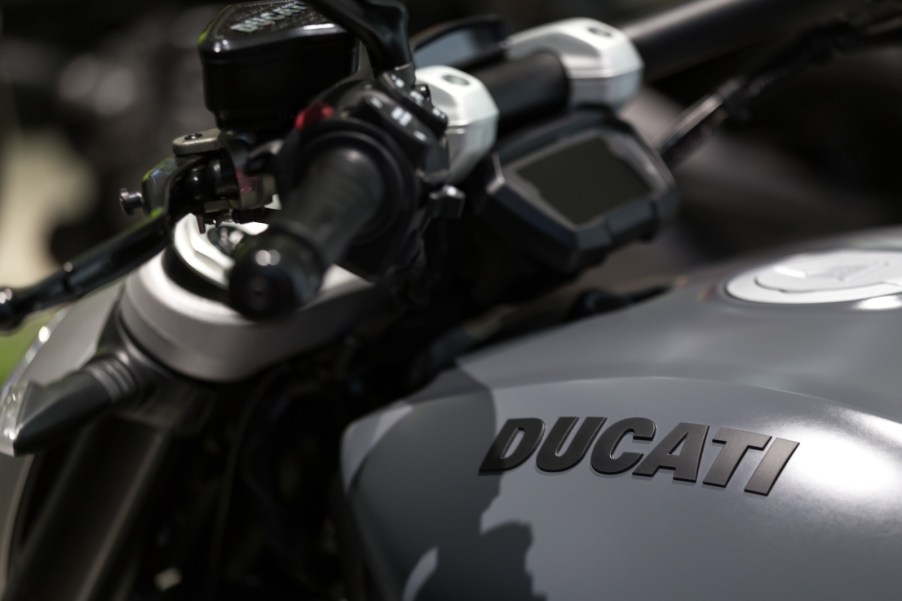 The tank and digital gauge cluster on a gray Ducati motorcycle