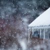 Icicles hanging from a roof during a snow storm.