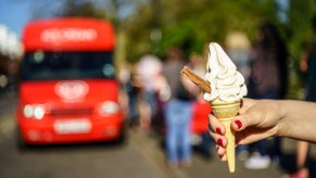 People getting ice cream from an ice cream truck