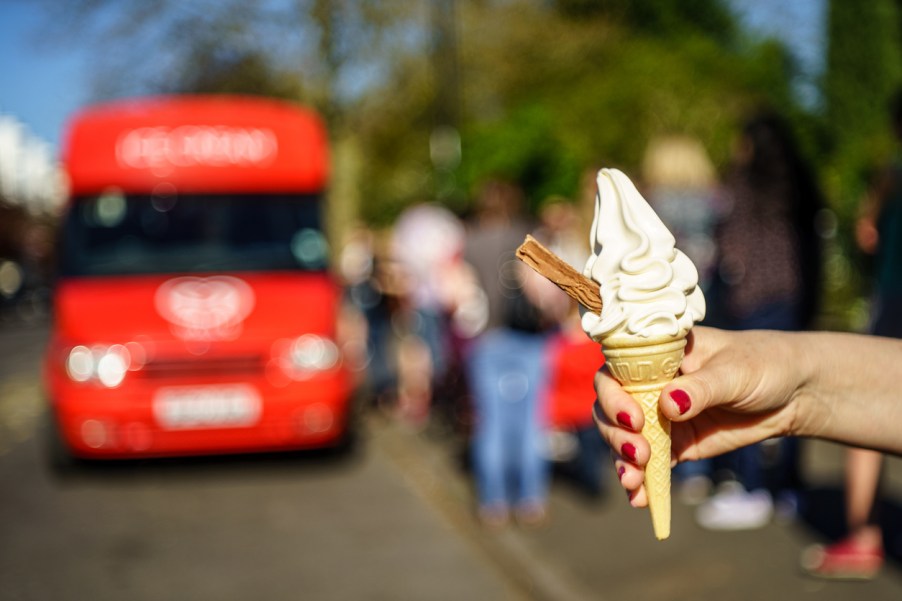 People getting ice cream from an ice cream truck