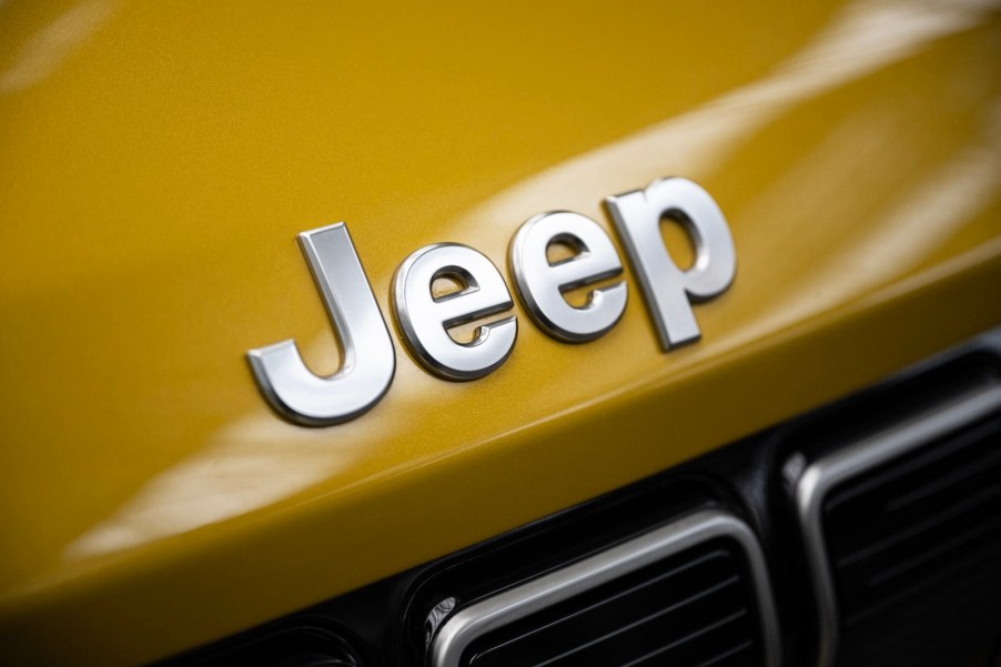 Chrome Jeep logo on the gold hood of an SUV.