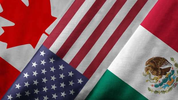 The Canadian, U.S., and Mexican national flags, stacked on top of one another