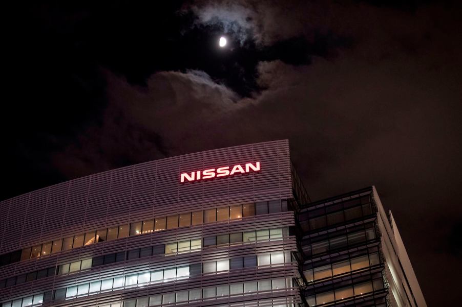 The Nissan sign above the headquarters office building in Japan, a full moon in the background.