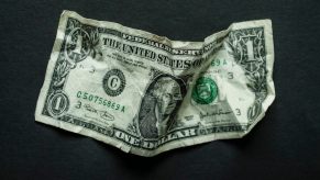 $1 bill on a black background.