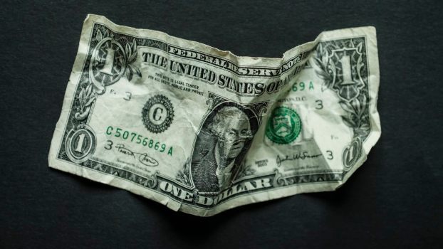 $1 bill on a black background.