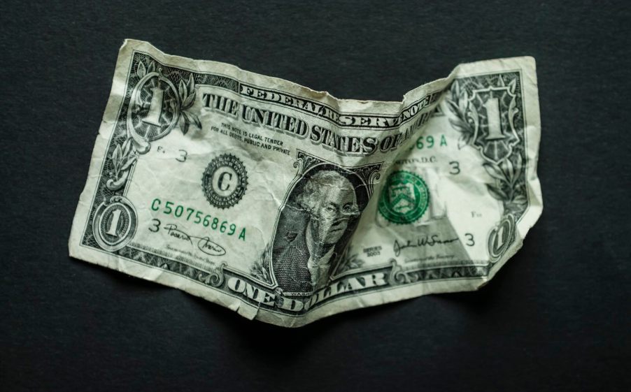 $1 bill on a black background.