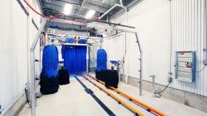 The bright white tunnel inside an automated car wash.