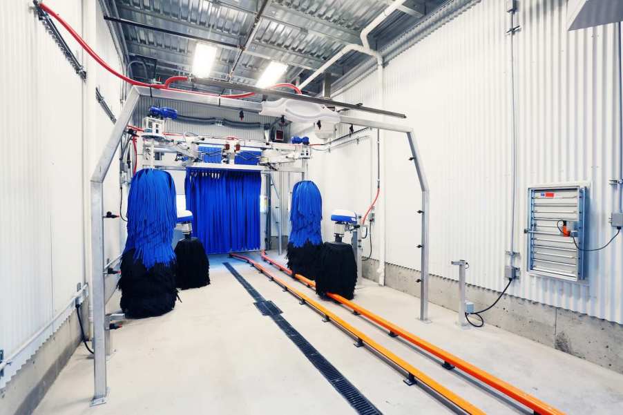 The bright white tunnel inside an automated car wash.