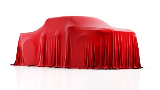 Chevrolet Silverado EV Trail Boss under a red cover.