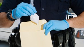 A police officer putting drugs in an envelope
