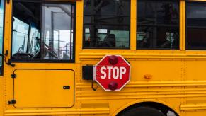 Red sign on a yellow school bus at a Florida stop.