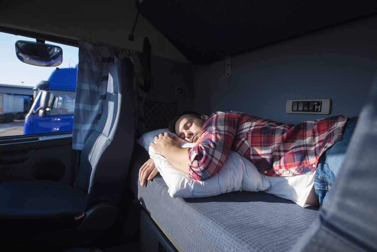A man sleeping in an RV