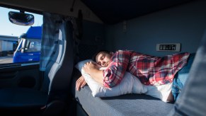 A man sleeping in an RV