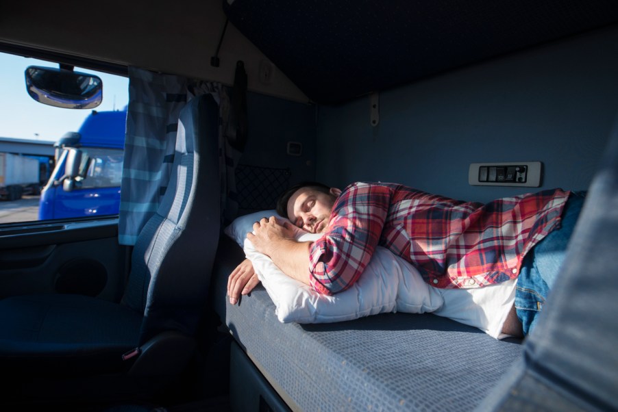 A man sleeping in an RV