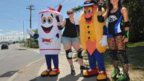 Sonic milkshake and cheese coney dogs stand with carhops on roller skates by the roadside.