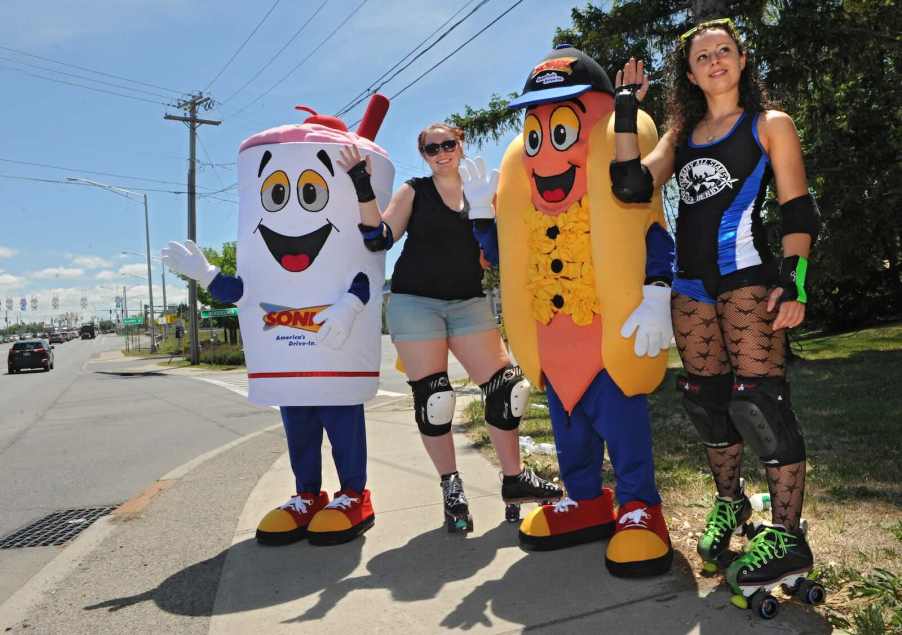 Sonic milkshake and cheese coney dogs stand with carhops on roller skates by the roadside.