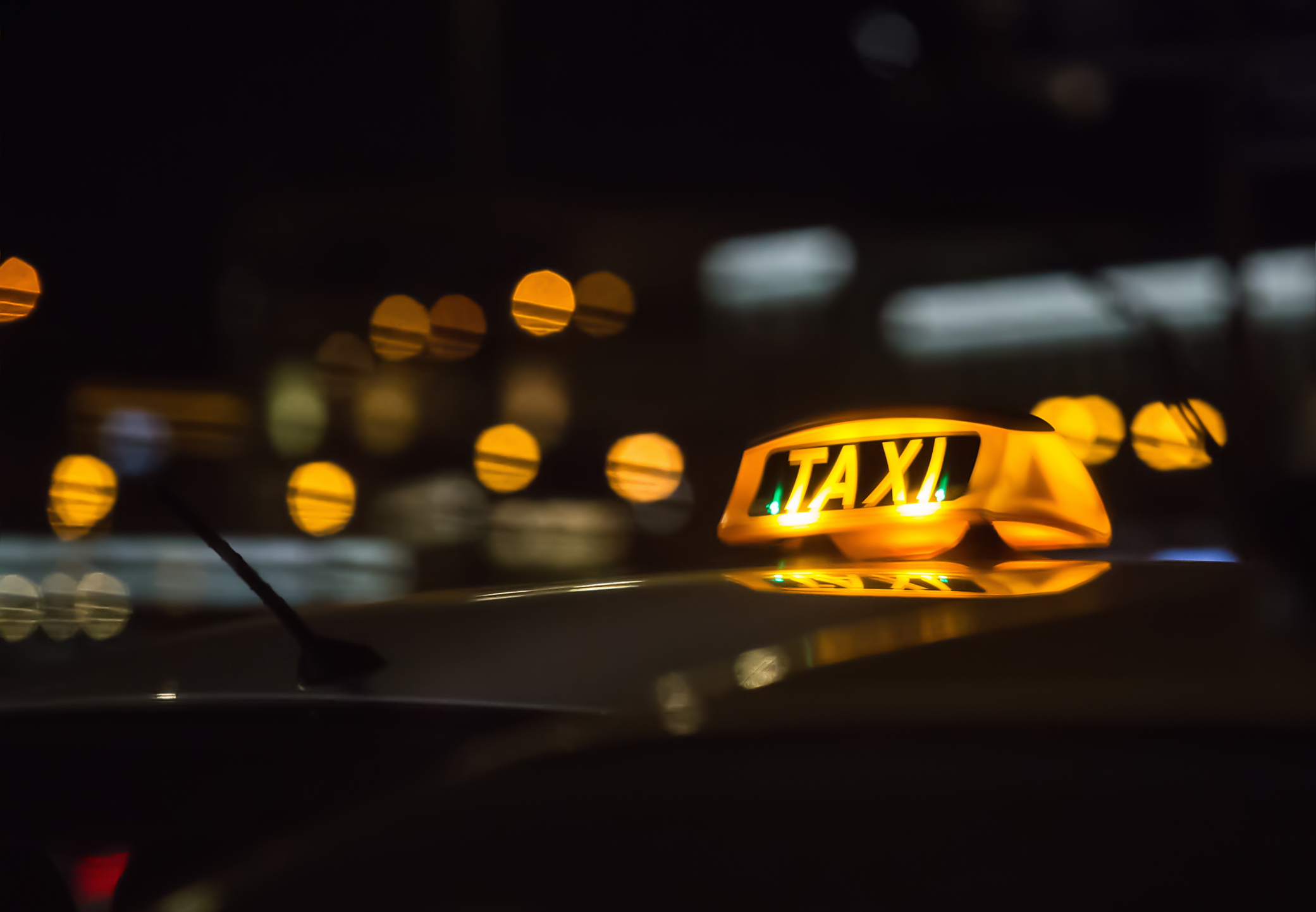 A Taxi sign at night