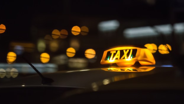 A Taxi sign at night