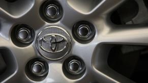 The Toyota logo on a Prius with doors that may fly open while driving.