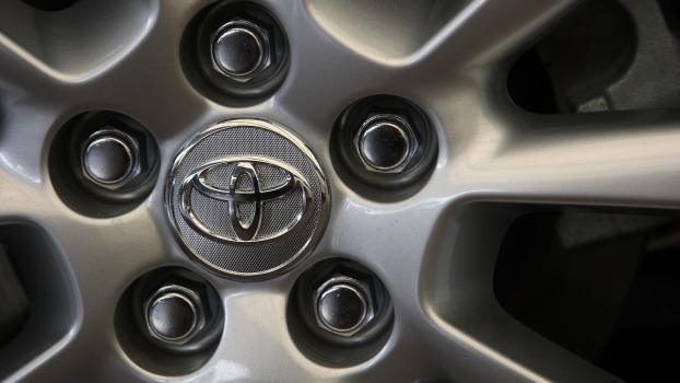 The Toyota logo on a Prius with doors that may fly open while driving.