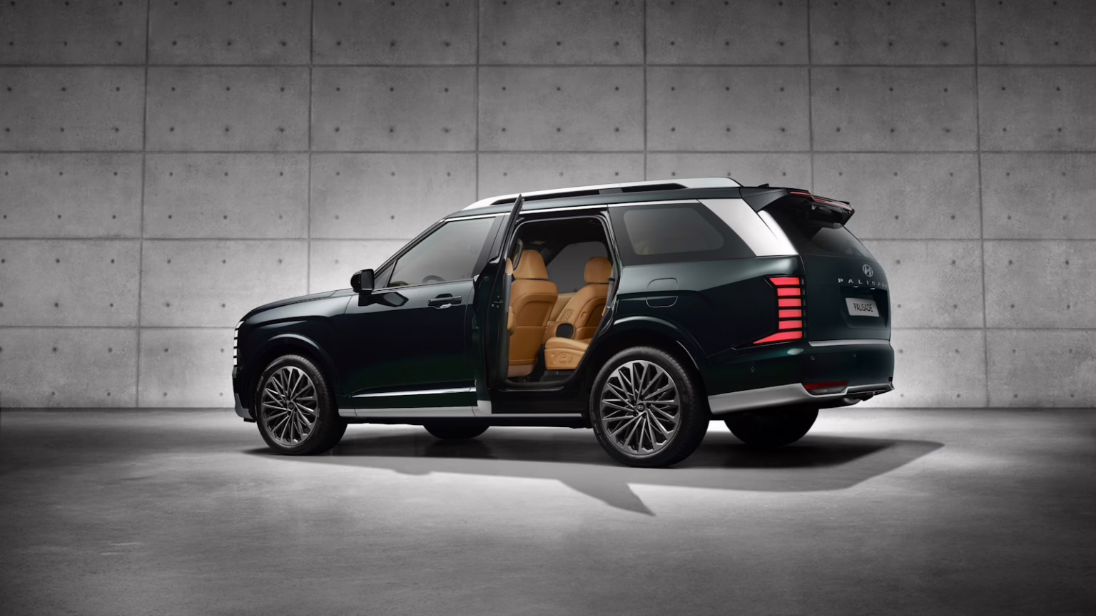 A luxury suv with open doors in a garage.