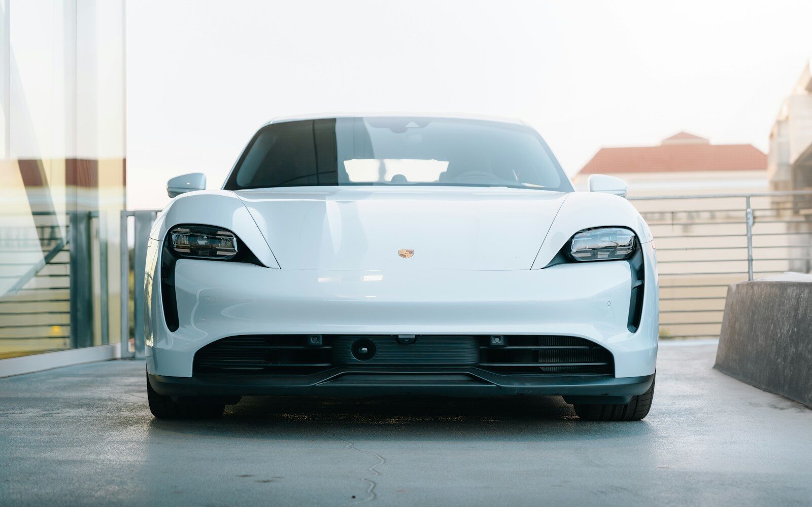 a white sports car parked in a garage. Porsche