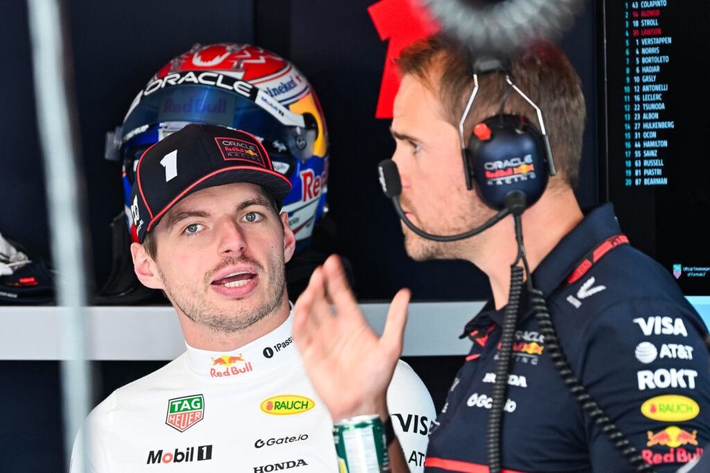 Jun 14, 2025; Montreal, Quebec, Canada; Red Bull Racing driver Max Verstappen (1) discusses with a technician during FP3 practice at Circuit Gilles-Villeneuve. Mandatory Credit: David Kirouac-Imagn Images