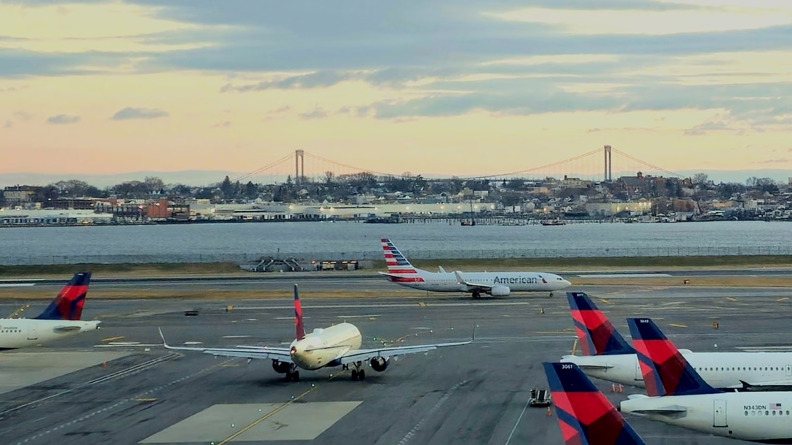 a bunch of airplanes that are on a runway LaGuardia Airport