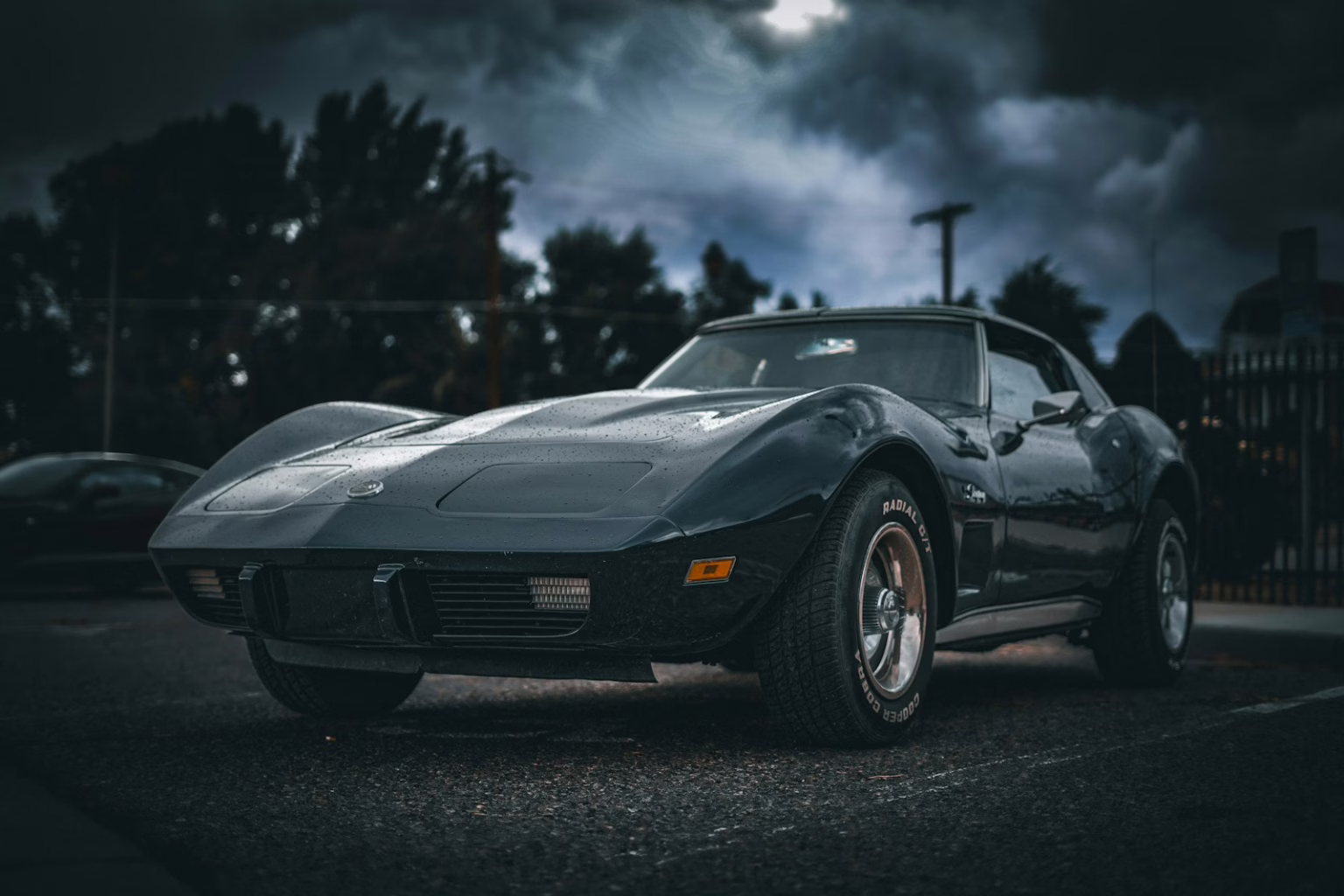 A car parked in a parking lot under a cloudy sky