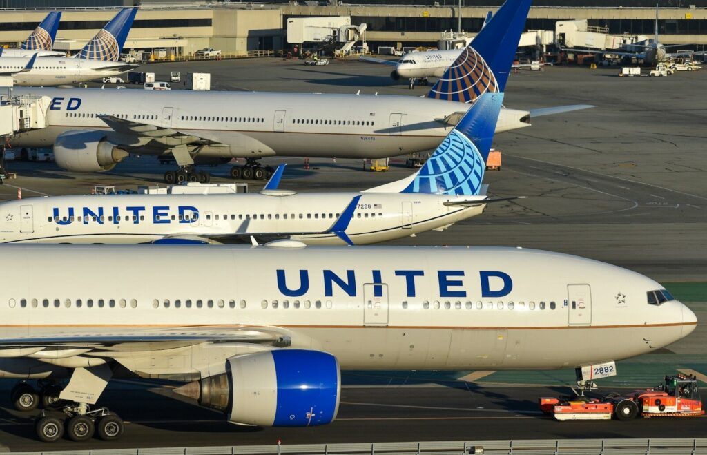 a couple of airplanes that are on a runway. FAA