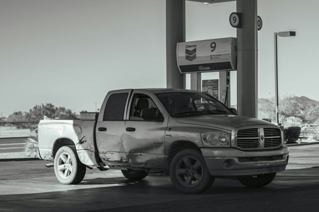 a truck parked in front of a gas station for fuel
