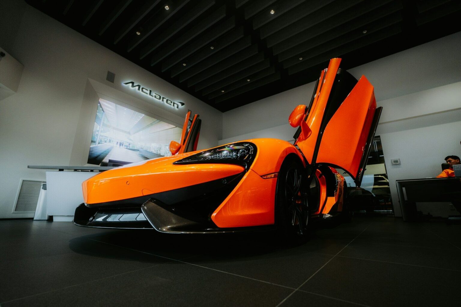 Orange mclaren sports car with doors open