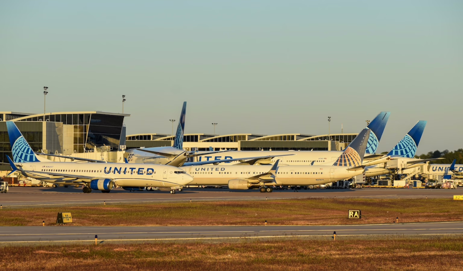 A bunch of airplanes that are on a runway