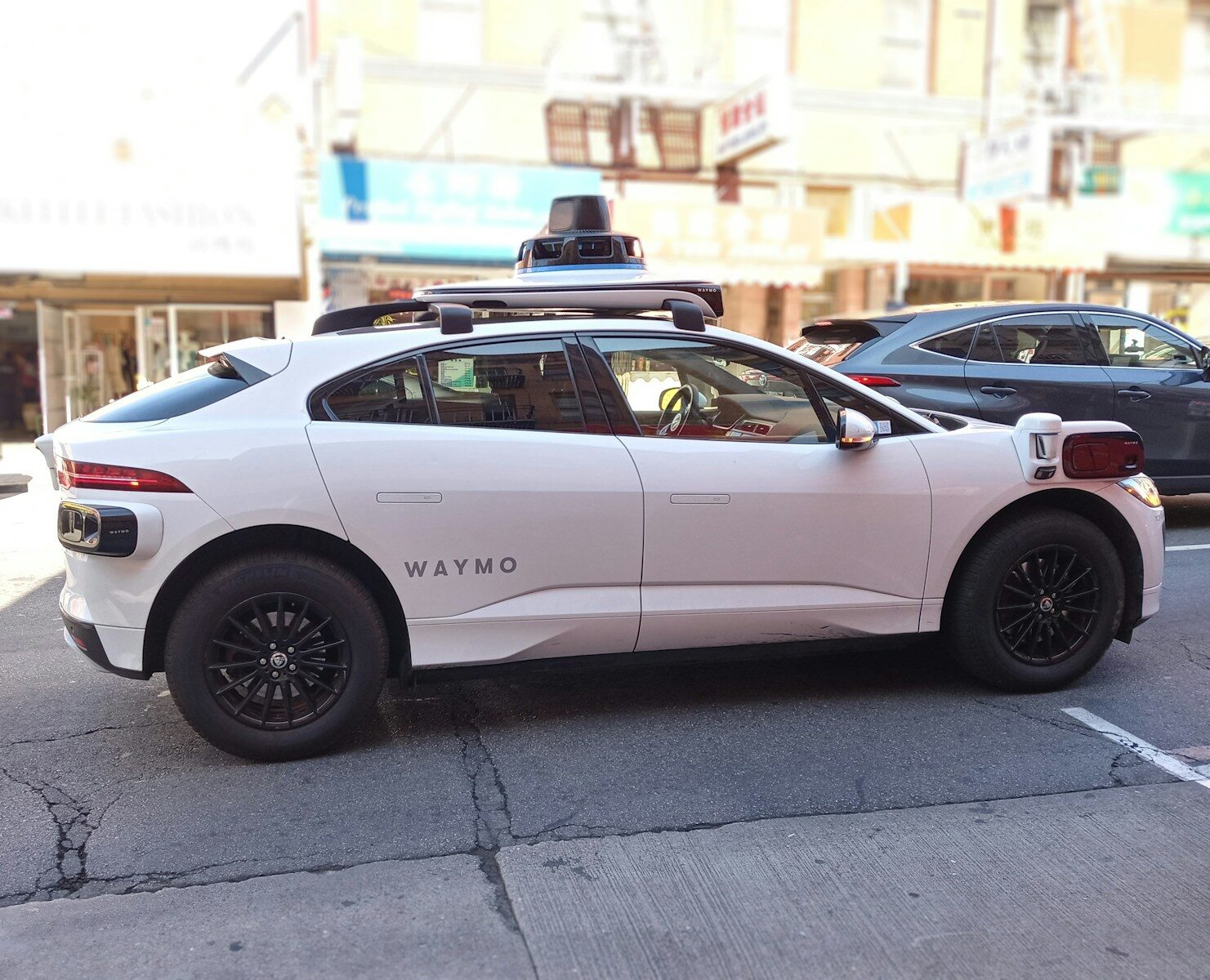 A waymo self-driving car is seen in the city.