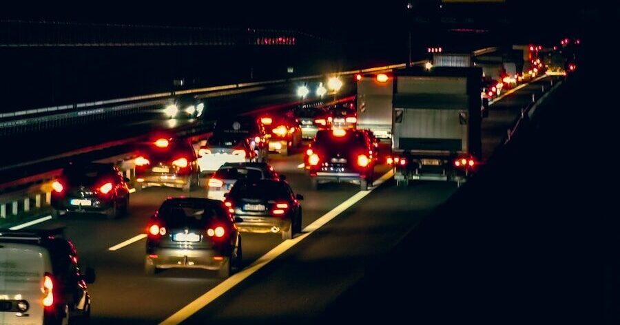 a highway filled with lots of traffic at night