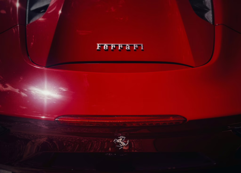 Red ferrari car emblem and taillight detail