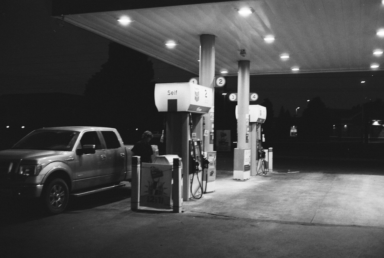Pickup truck at a gas station at night