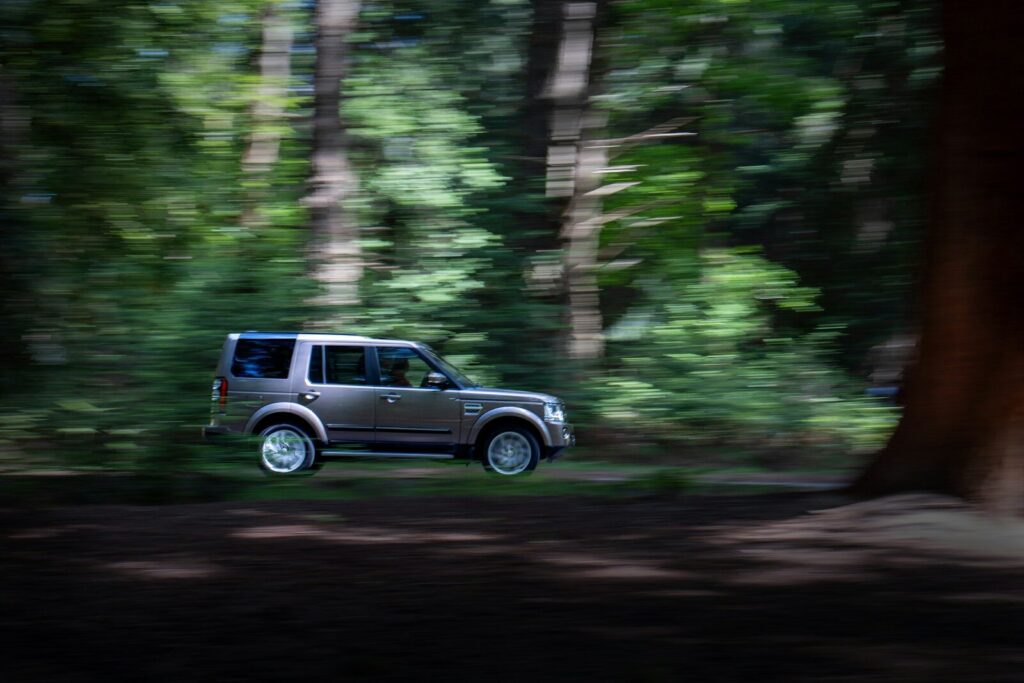 A car drives rapidly through the forest. police