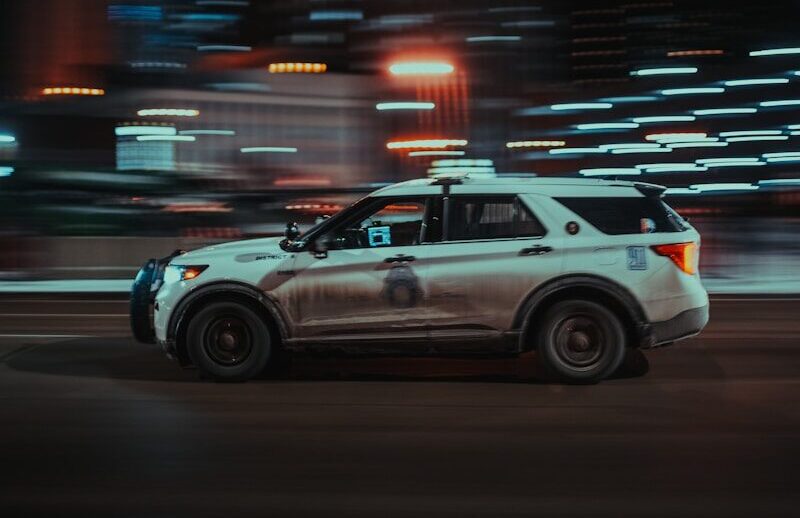 a police car driving down a city street at night